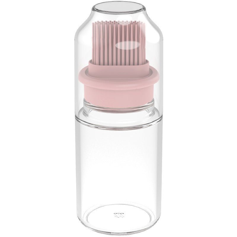Portable oil bottle with silicone brush in light pink and transparent glass, for controlled oil dispensing, ideal for home cooks, silicone oil brush by Innopick.